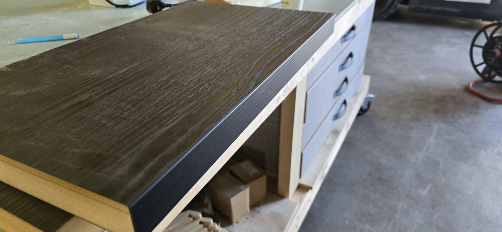 Dark woodgrain laminated worktop with edge banding