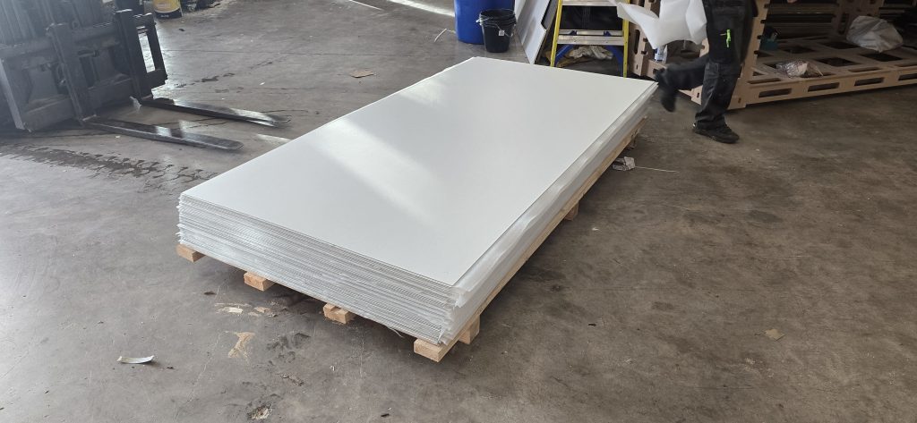 White laminated sheets stacked ready for cutting
